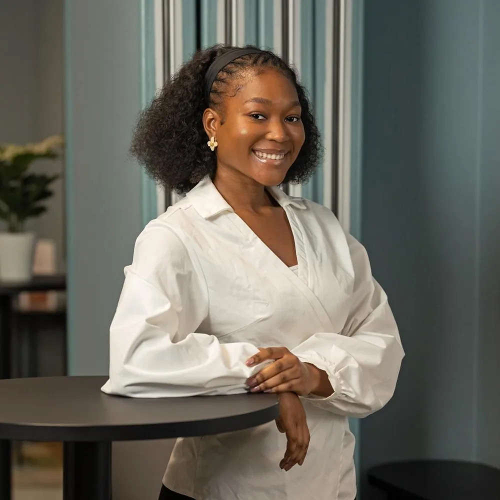 Timi Adepegba, Maths, Science and Engineering tutor, smiling in a white shirt